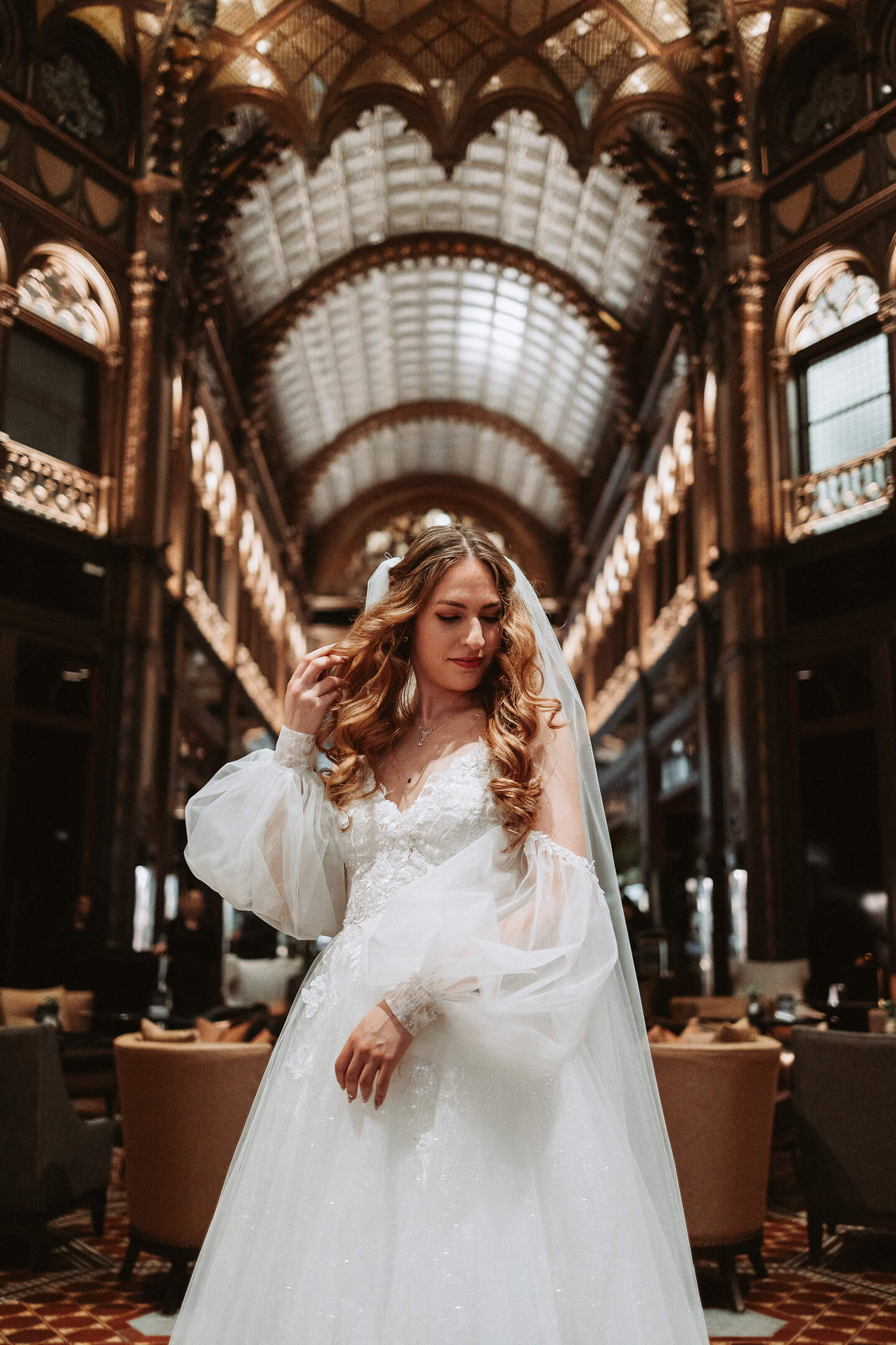 A bride in an elegant wedding gown at a luxurious venue.