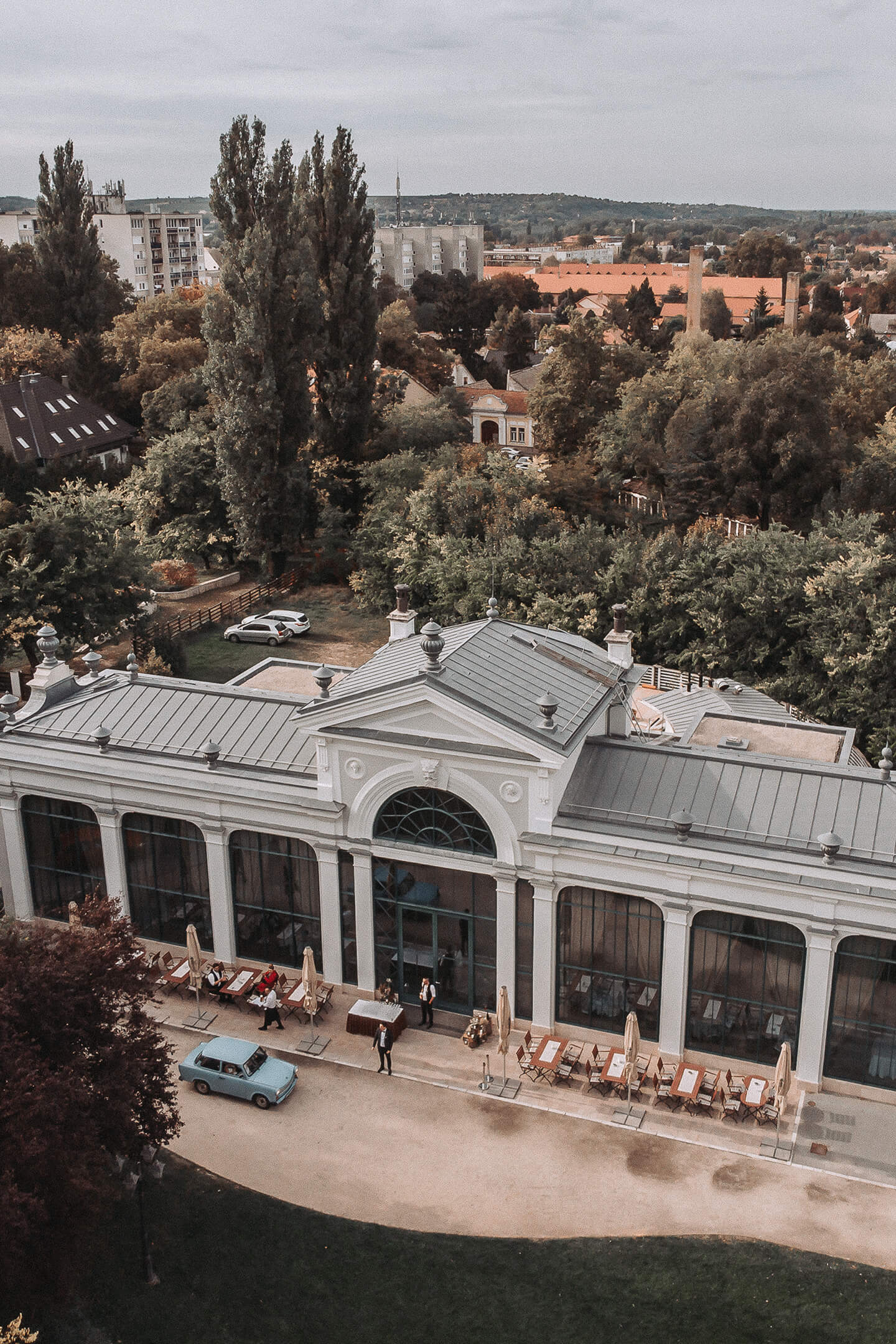 An aerial view of an elegant wedding venue surrounded by lush green trees.